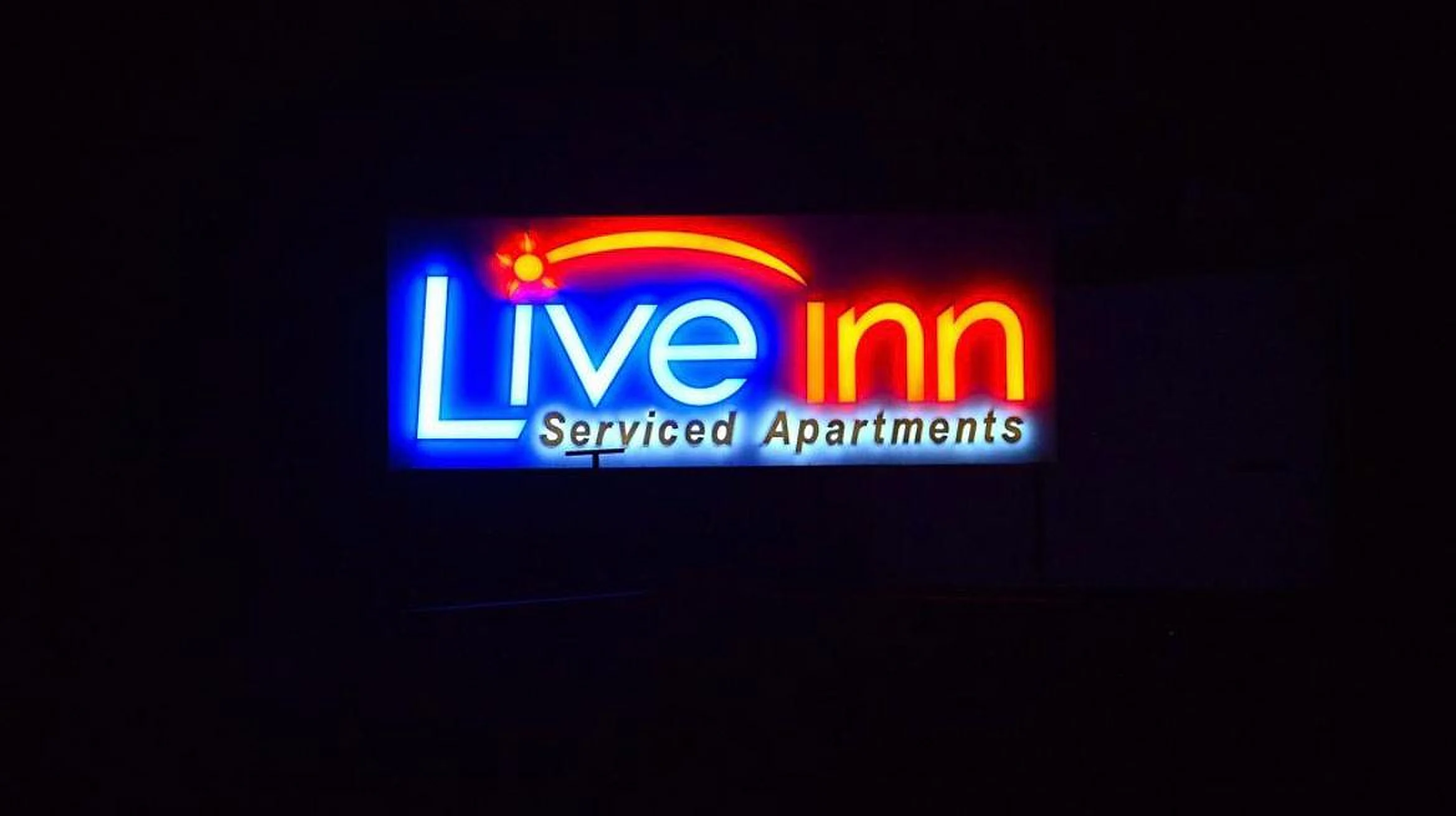 Multicolour LED sign board for serviced apartments at night